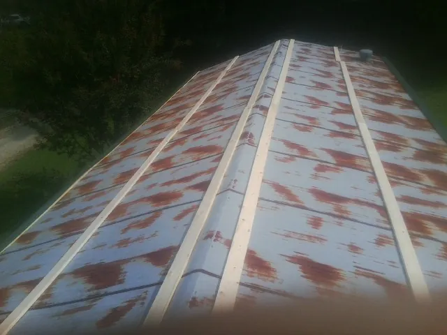 Rusted metal roof panels with new wood purlins before replacement — Storm Damage Roof Repair in Beallsville by Roofing Brothers