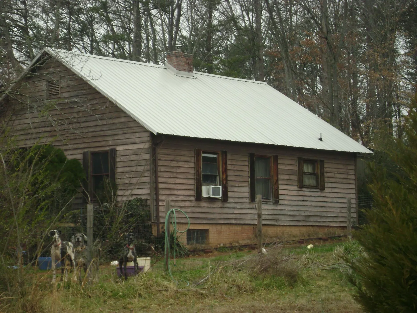 White metal roof on an old wood sided farmhouse, from a Metal Roof Installation job in Beallsville